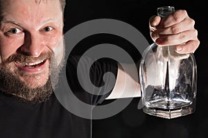 Man holding empty bottle of alcohol