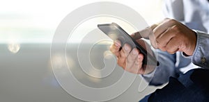 Man holding en hands and using digital tablet  Mobile Phone telephone with blank copy space scree