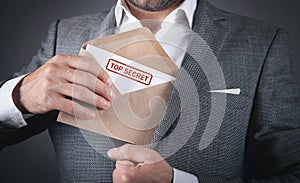 Man holding envelope with top secret stamp