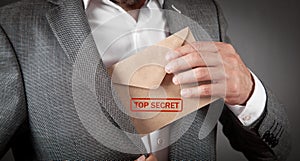 Man holding envelope with top secret stamp