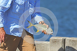 Man holding a fish.