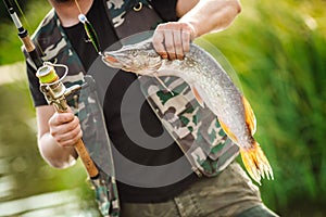 Man holding a fish on the river