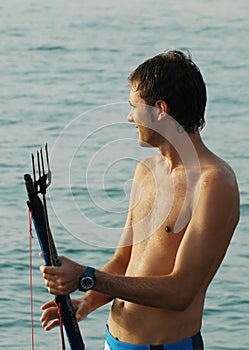 Man holding fishing harpoon photo