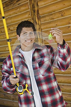 Man holding fishing rod and lure