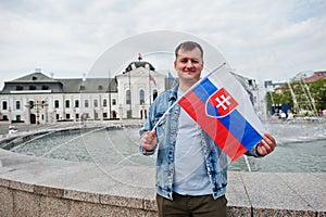 Man holding flag at Grassalkovich Palace, Bratislava, Europe. Residence of the president of Slovakia in Bratislava