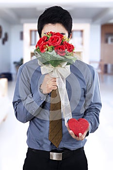 Man holding flowers and gift