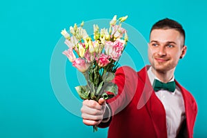Man holding flowers on Valentine`s Day, turquoise background photo