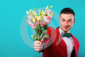 Man holding flowers on Valentine`s Day, turquoise background photo