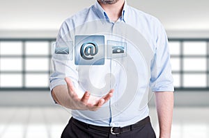 Man holding futuristic contact us floating icons