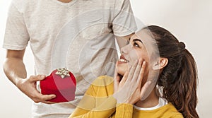 Man holding gift box and giving girlfriend