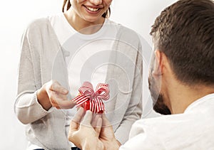 Man holding gift box and giving girlfriend