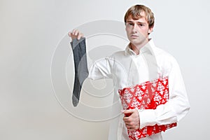 Man holding gift and sock