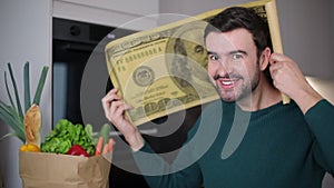 Man holding gigantic 100 dollars bill