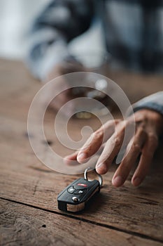 Man holding a glass of brandy, he is drinking brandy in a bar, drinking alcohol impairs driving ability and can damage health. The