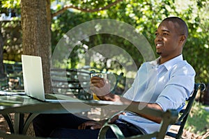 Man holding glass of orange juice at restaurant