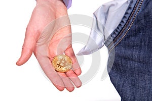 Man holding golden botcoin and showing his empty pocket.