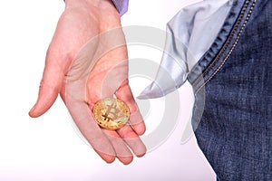 Man holding golden botcoin and showing his empty pocket.