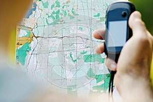 Man holding a GPS receiver and plan in his hand.