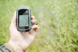 Man holding a GPS receiver and plan in his hand.