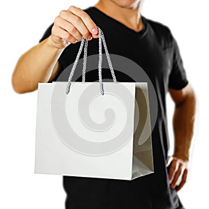 A man holding a gray gift bag. Close up. Isolated on white background