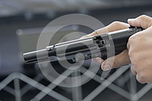 Man holding gun aiming pistol in hand ready to shoot