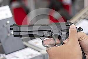 Man holding gun aiming pistol in hand ready to shoot