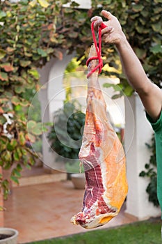 Man holding hammon pork leg in the hand photo