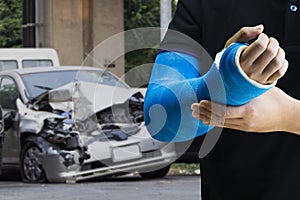 Man holding hand with blue bandage as arm injury with car accident concept