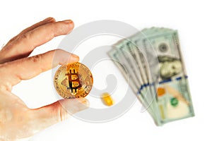 Man holding in hand gold Bitcoin on white background