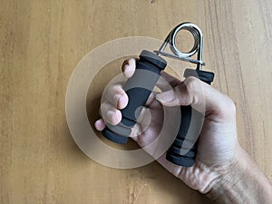 A man holding handgrip for hand exercise
