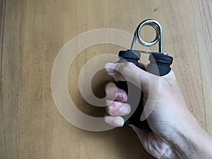 A man holding handgrip for hand exercise