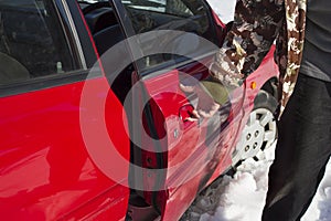 The man is holding the handle and opens the car door