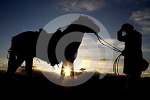 Man holding hat and horse