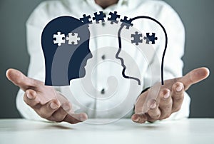 Man holding heads with puzzle pieces. Problem solving concept