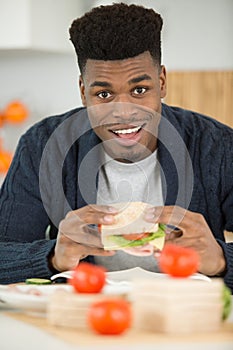 man holding healthy salad sandwich