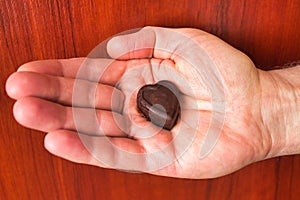 A man holding a heart shaped chocolate candy