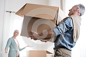 Man holding heavy cardboard box at new home