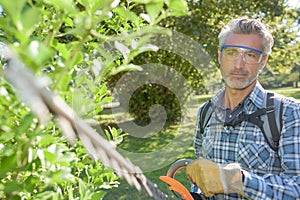 Man holding hedge trimmer
