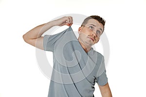 man holding himself by the shoulders on white background