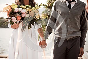 Man holding a his bride hand on the wedding ceremony