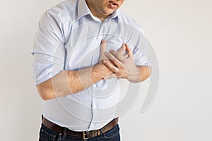 Man holding his chest in pain. Heart attack symptom photo