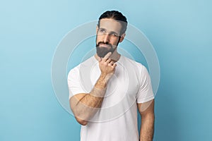 Man holding his chin and pondering idea, confused not sure about solution.