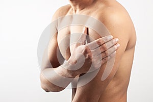 Man holding his deltoids muscle photo