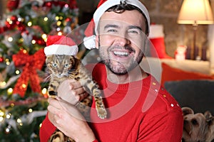 Man holding his evil cat during Christmas