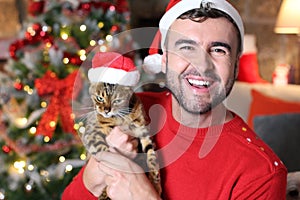 Man holding his evil cat during Christmas