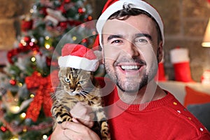 Man holding his evil cat during Christmas