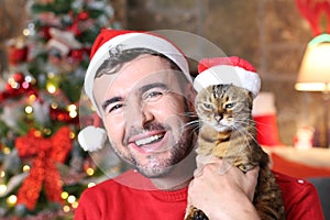 Man holding his evil cat during Christmas