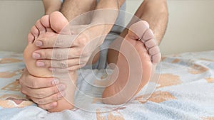 Man holding his foot when feeling pain in the instep and sole of the foot photo