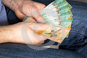 A man holding in his hands Costa Rica money, Banknotes of various values