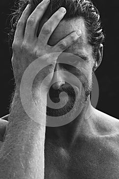 Man holding his head in remorse or regret photo